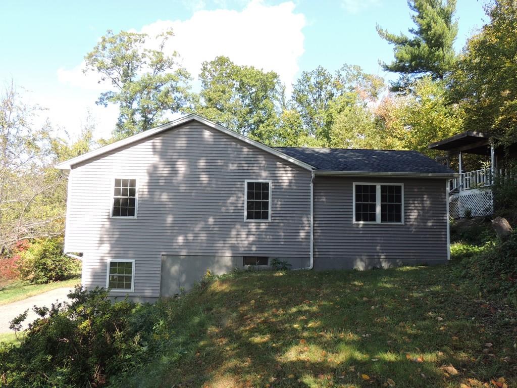 68 Cote Road Monson, MA 01057 - Photo 5 of 24 a front view of house with yard and trees in the background