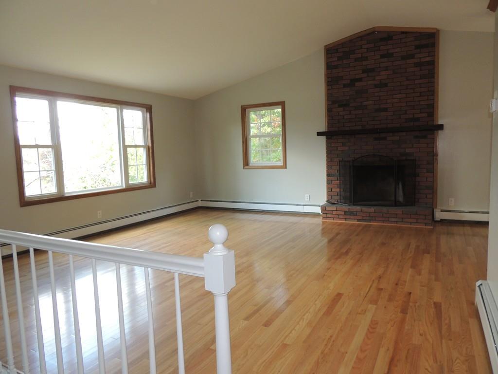 68 Cote Road Monson, MA 01057 - Photo 8 of 24 a view of an empty room with wooden floor fireplace and a window