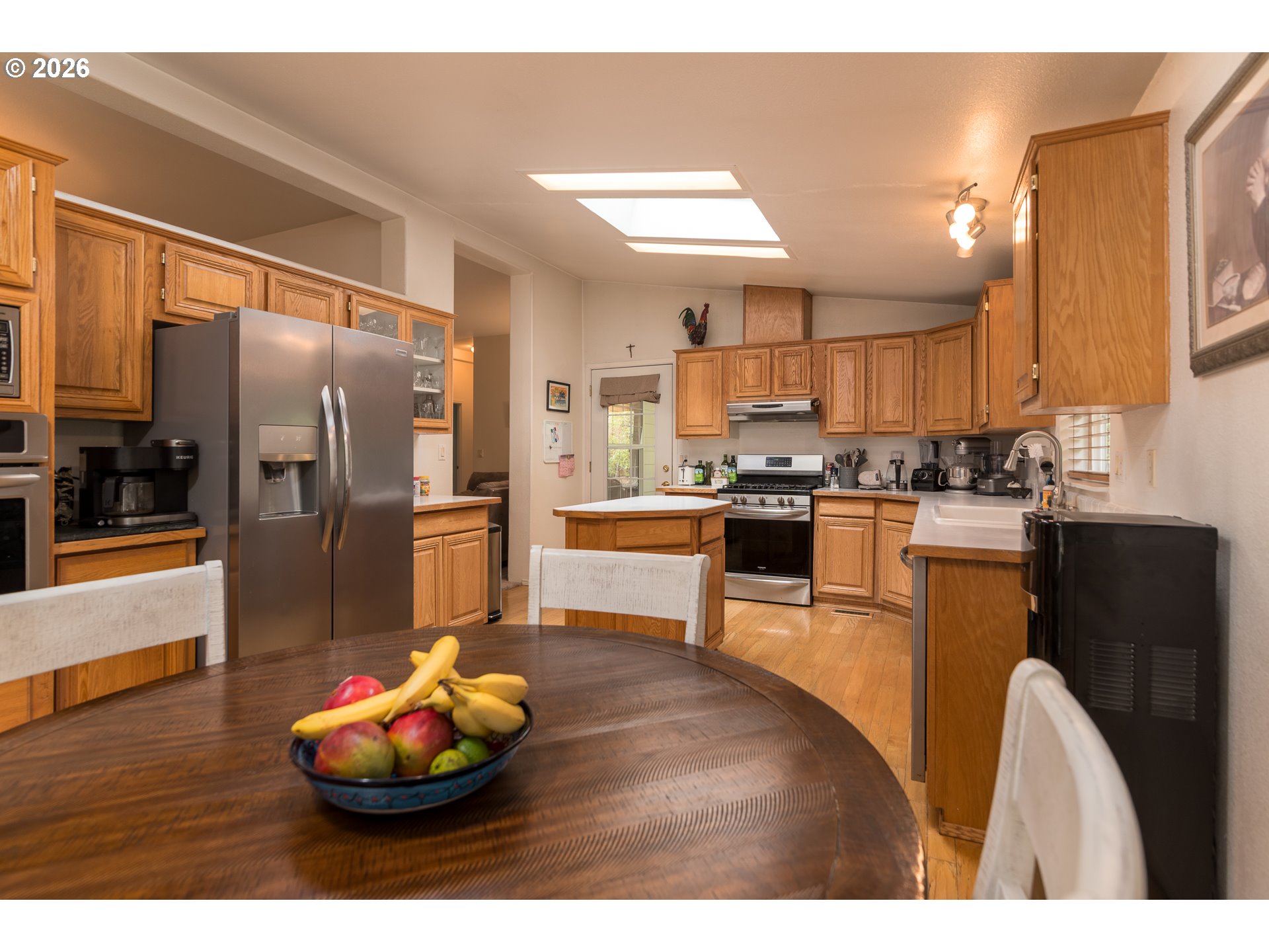 1157 8th Street Bandon, OR 97411 - Photo 2 of 46 a kitchen with stainless steel appliances wooden cabinets and refrigerator