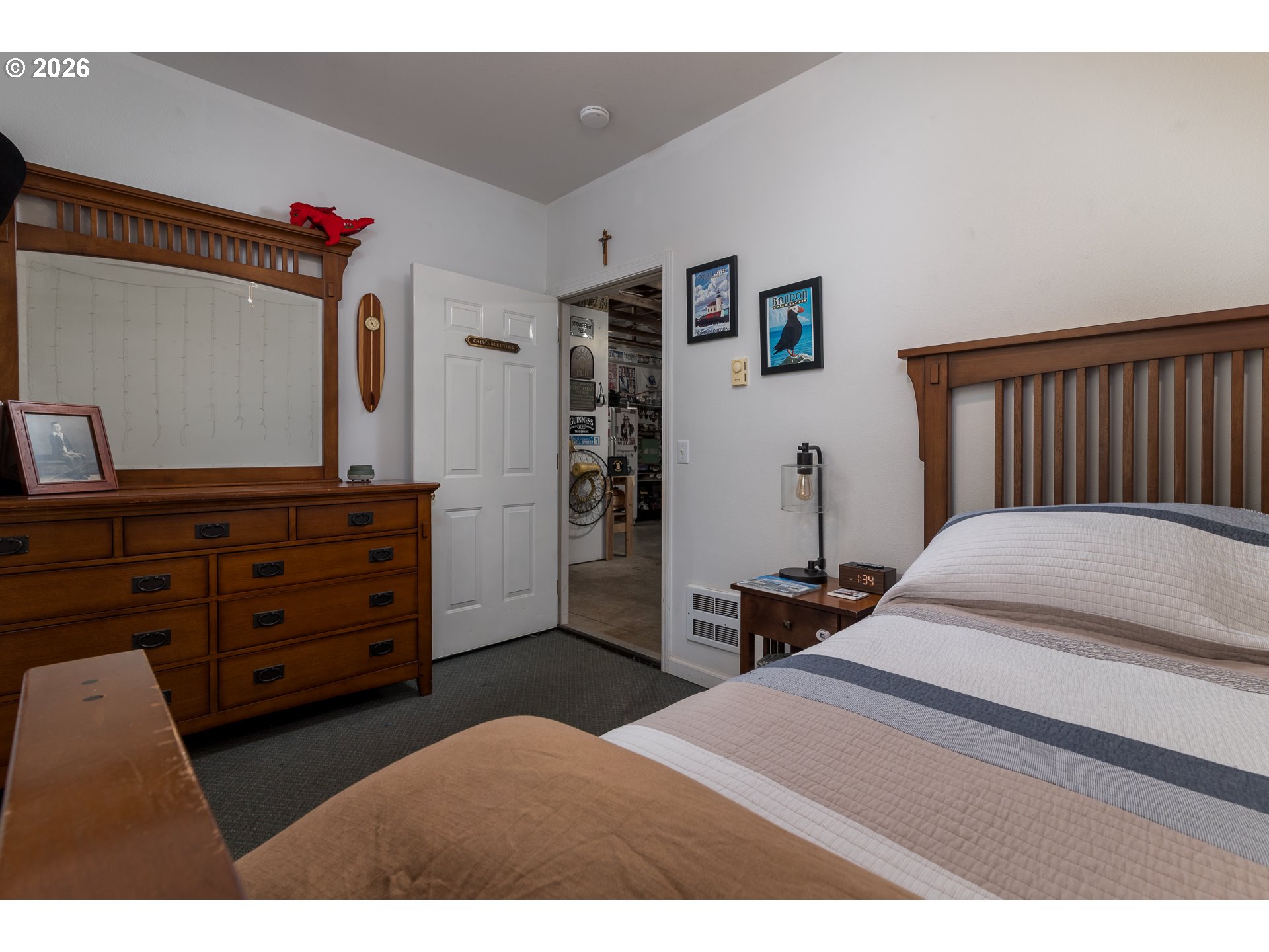1157 8th Street Bandon, OR 97411 - Photo 28 of 46 a bedroom with a bed and a dresser in it
