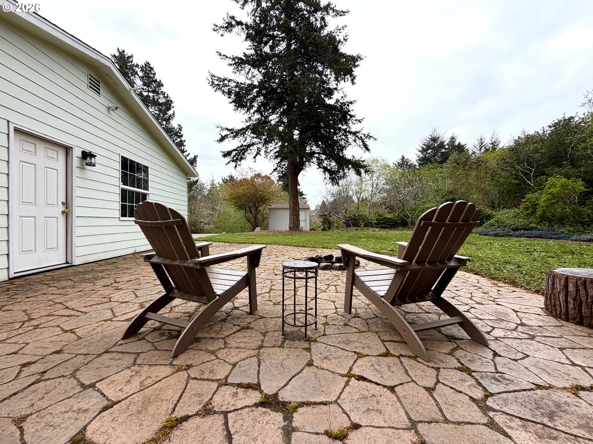 1157 8th Street Bandon, OR 97411 - Photo 3 of 46 a view of backyard with table and chairs and wooden fence