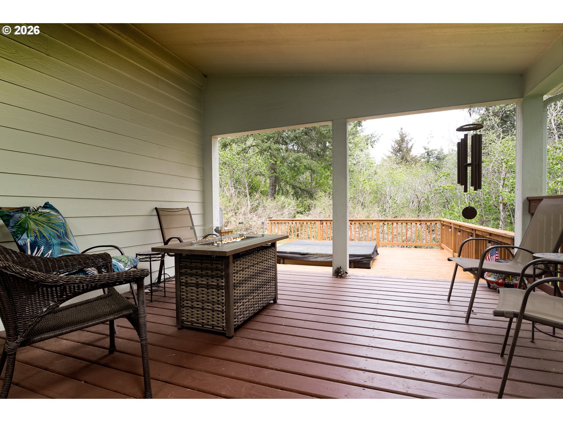 1157 8th Street Bandon, OR 97411 - Photo 31 of 46 a view of a patio with dining table and chairs with wooden floor