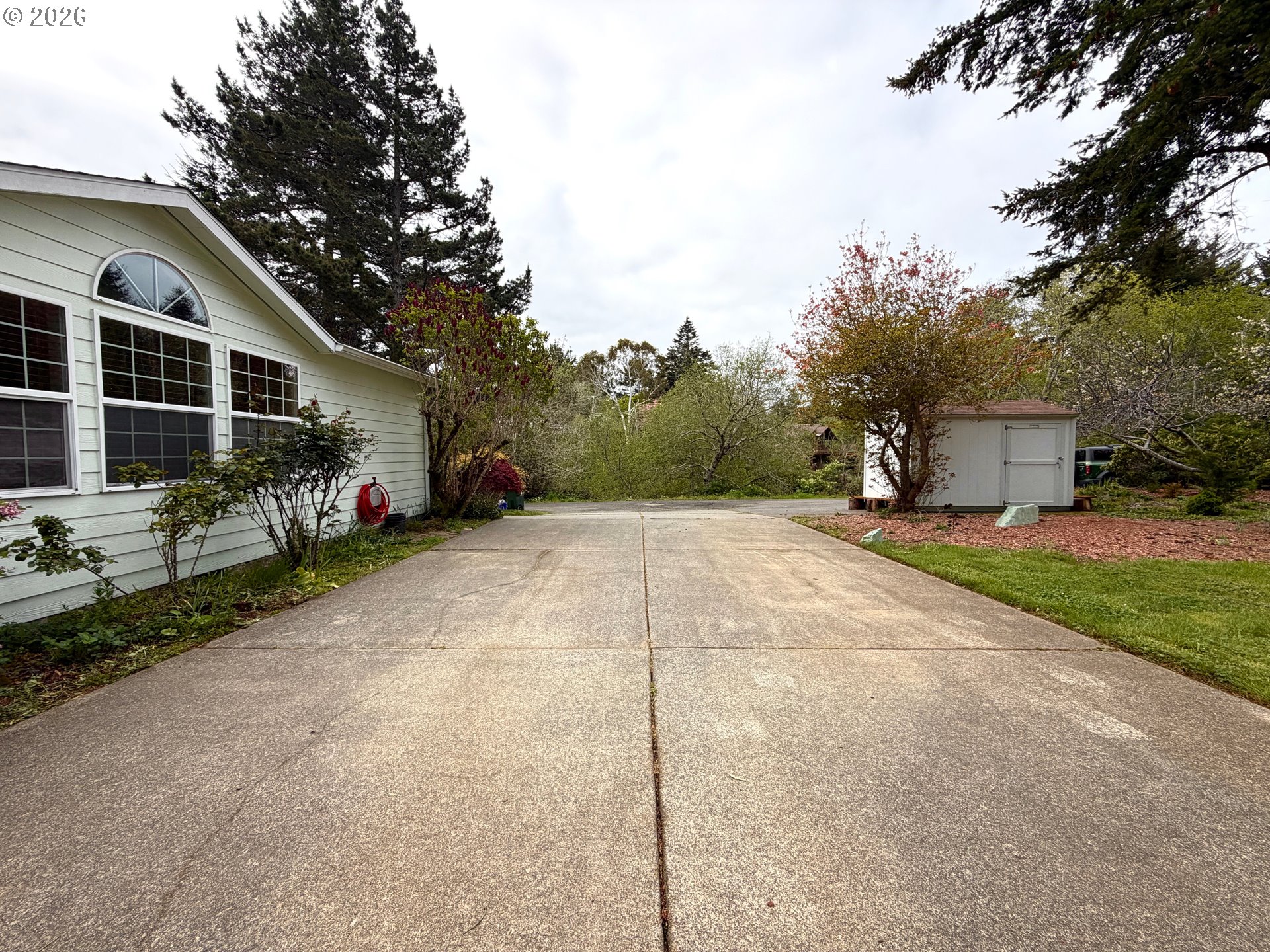 1157 8th Street Bandon, OR 97411 - Photo 36 of 46 a view of a house with backyard and sitting area