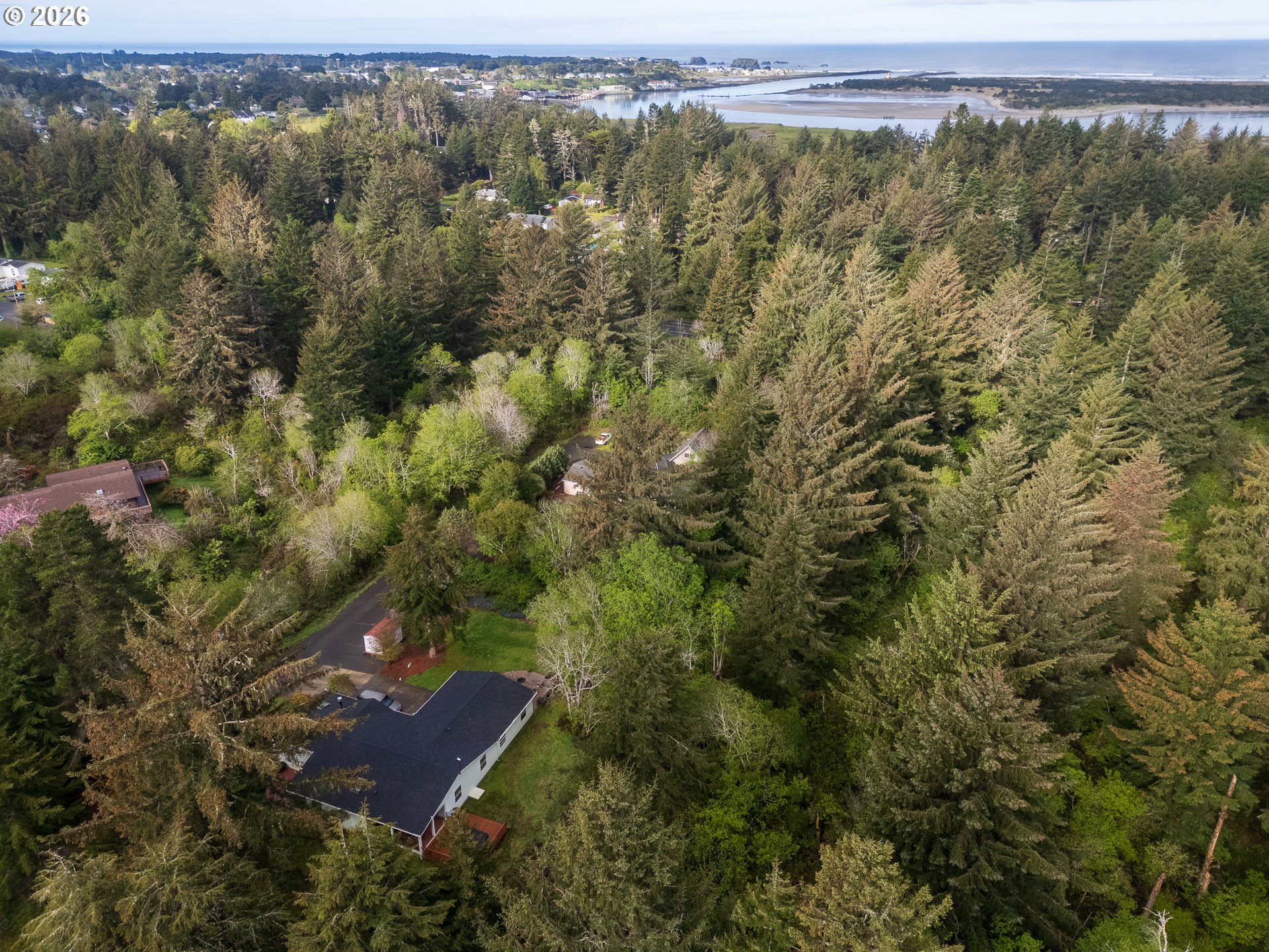 1157 8th Street Bandon, OR 97411 - Photo 41 of 46 an aerial view of a house with a yard