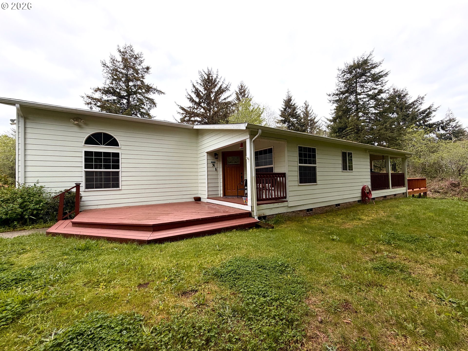 1157 8th Street Bandon, OR 97411 - Photo 6 of 46 a front view of house with yard and green space