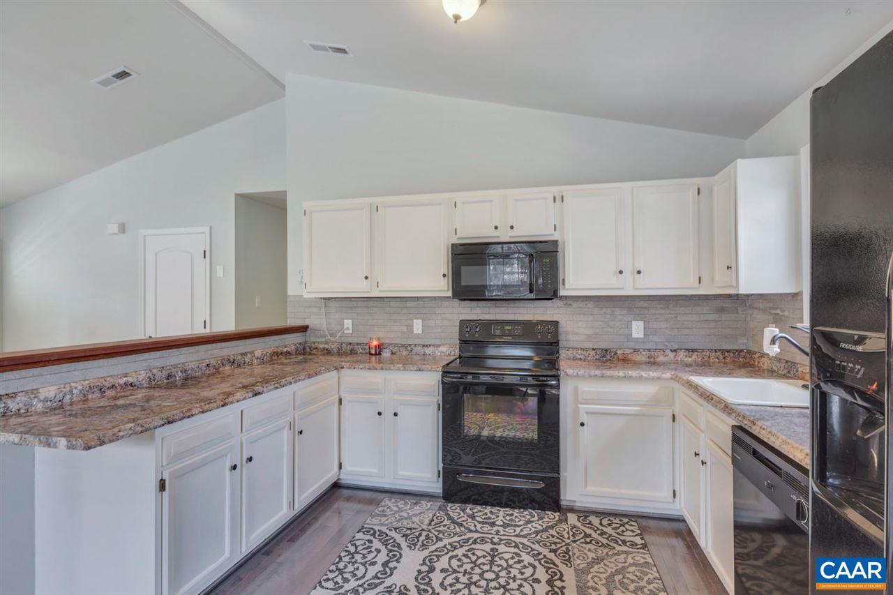 127 Larkspur Road Ruckersville, VA 22968 - Photo 12 of 29 a kitchen with stainless steel appliances granite countertop a sink stove and cabinets