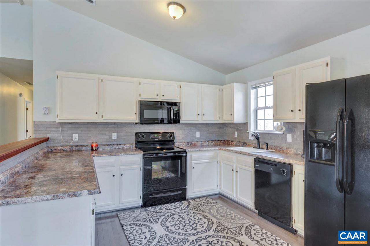 127 Larkspur Road Ruckersville, VA 22968 - Photo 13 of 29 a kitchen with stainless steel appliances granite countertop a refrigerator sink and stove