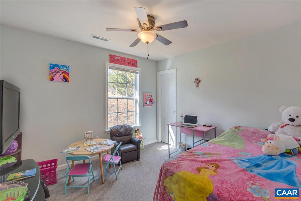 127 Larkspur Road Ruckersville, VA 22968 - Photo 18 of 29 a bedroom with a bed and a chandelier