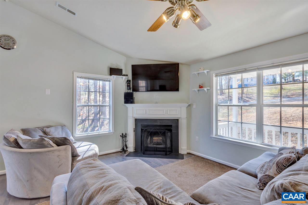 127 Larkspur Road Ruckersville, VA 22968 - Photo 7 of 29 a living room with furniture a flat screen tv and a fireplace