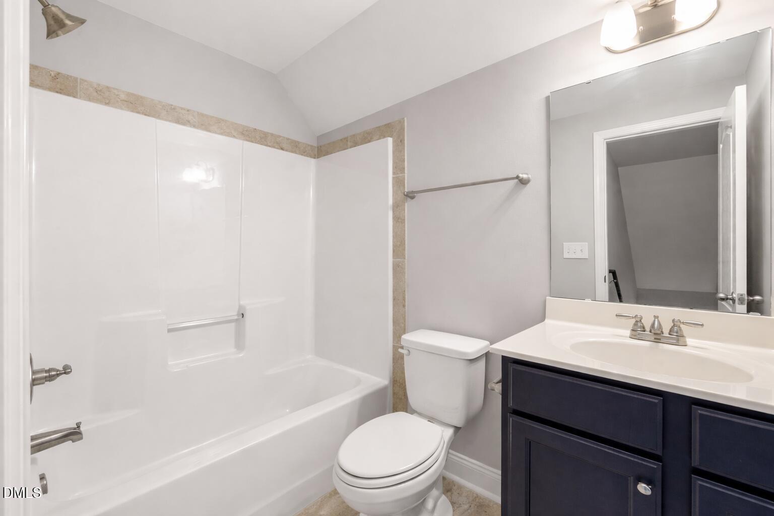 3401 Grosbeak Way Raleigh, NC 27616 - Photo 11 of 13 a bathroom with a sink a toilet and shower