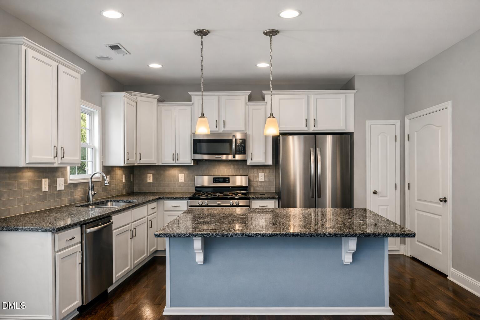 3401 Grosbeak Way Raleigh, NC 27616 - Photo 2 of 13 a kitchen with stainless steel appliances granite countertop a refrigerator a stove a sink and white cabinets