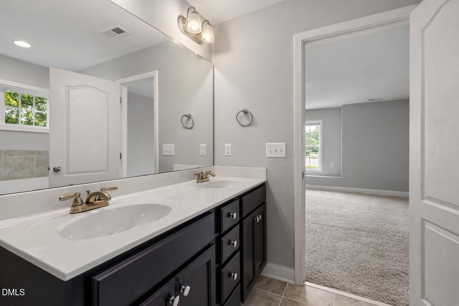 3401 Grosbeak Way Raleigh, NC 27616 - Photo 3 of 13 a bathroom with a sink vanity and a mirror