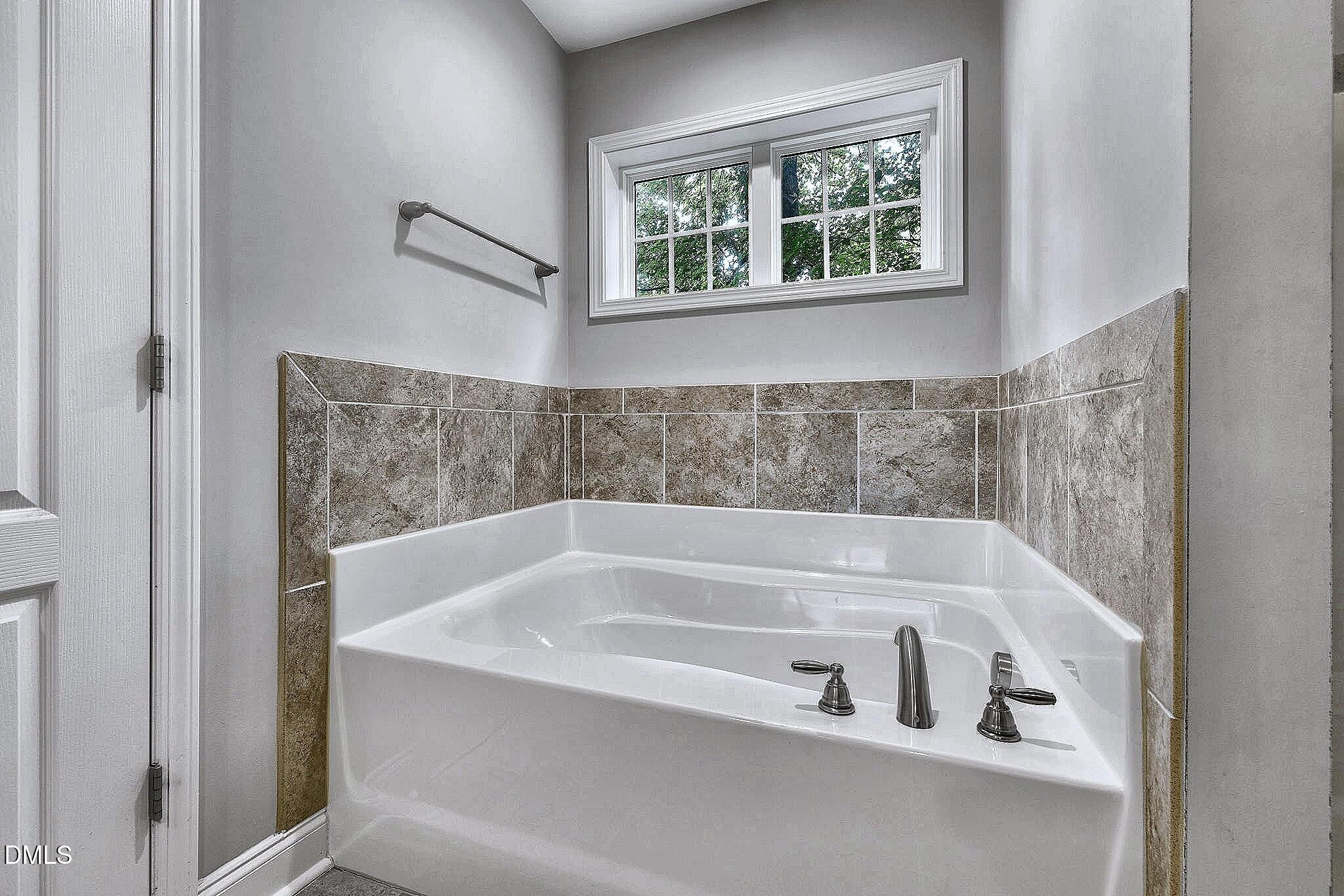 3401 Grosbeak Way Raleigh, NC 27616 - Photo 6 of 13 a white bath tub sitting next to a window