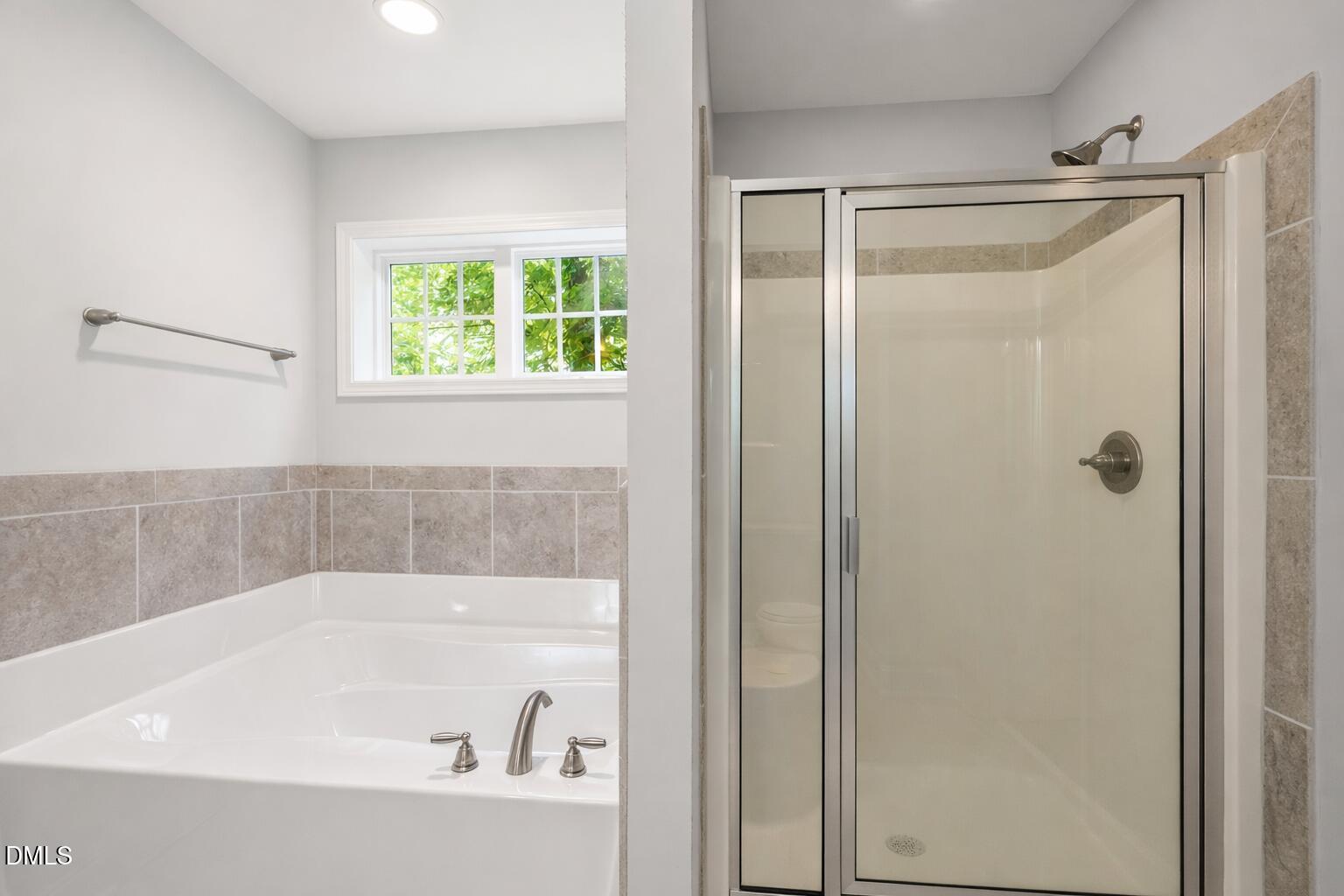 3401 Grosbeak Way Raleigh, NC 27616 - Photo 9 of 13 a bathroom with a bathtub and a shower