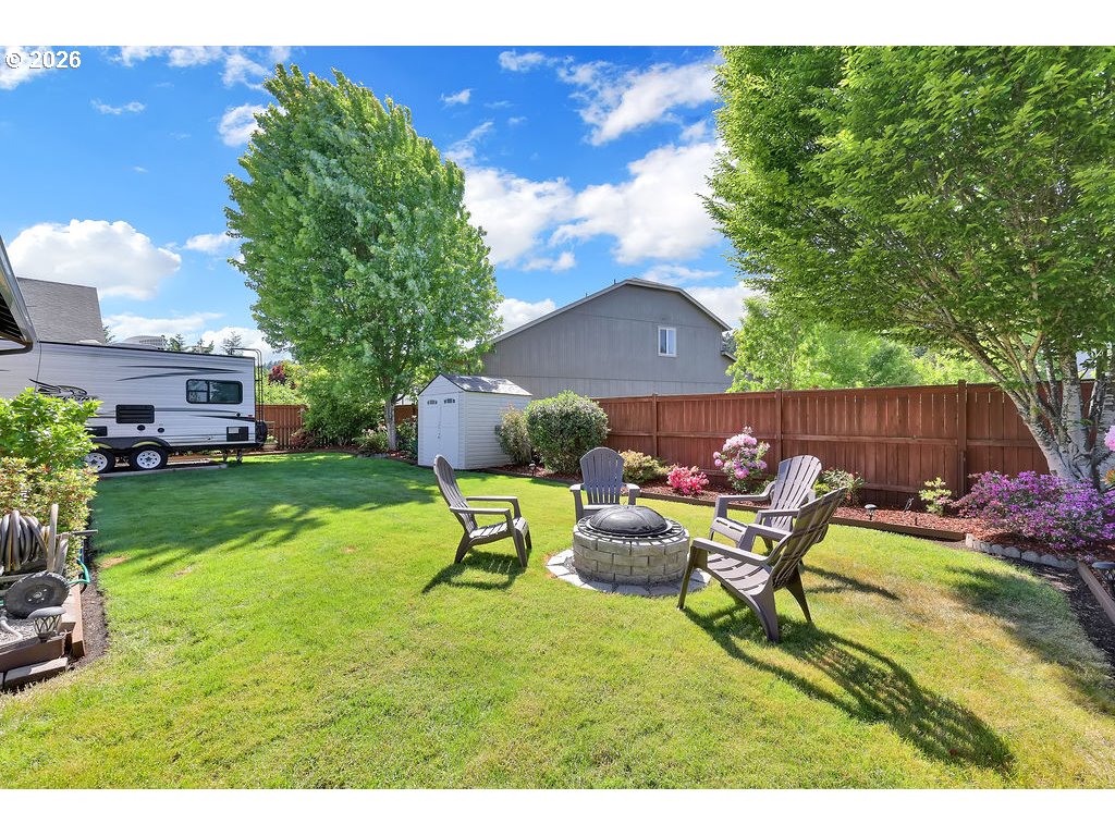 87836 8th Street Veneta, OR 97487 - Photo 24 of 25 a view of a backyard with table and chairs potted plants and a fire pit