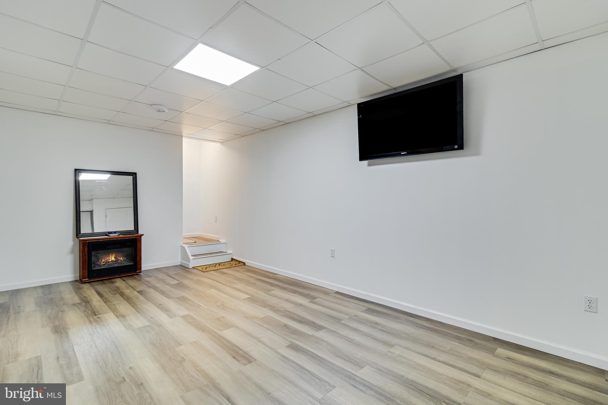 12015 Woodbury Road Nanjemoy, MD 20662 - Photo 42 of 53 a view of empty room with wooden floor and fan