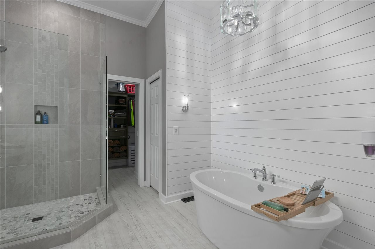 12205 Arneson Street Raleigh, NC 27614 - Photo 19 of 30 This en suite is just STUNNING! Every detail was well thought out from the light fixtures, to the mirrors, frameless shower, free standing tub. En suite fully updated