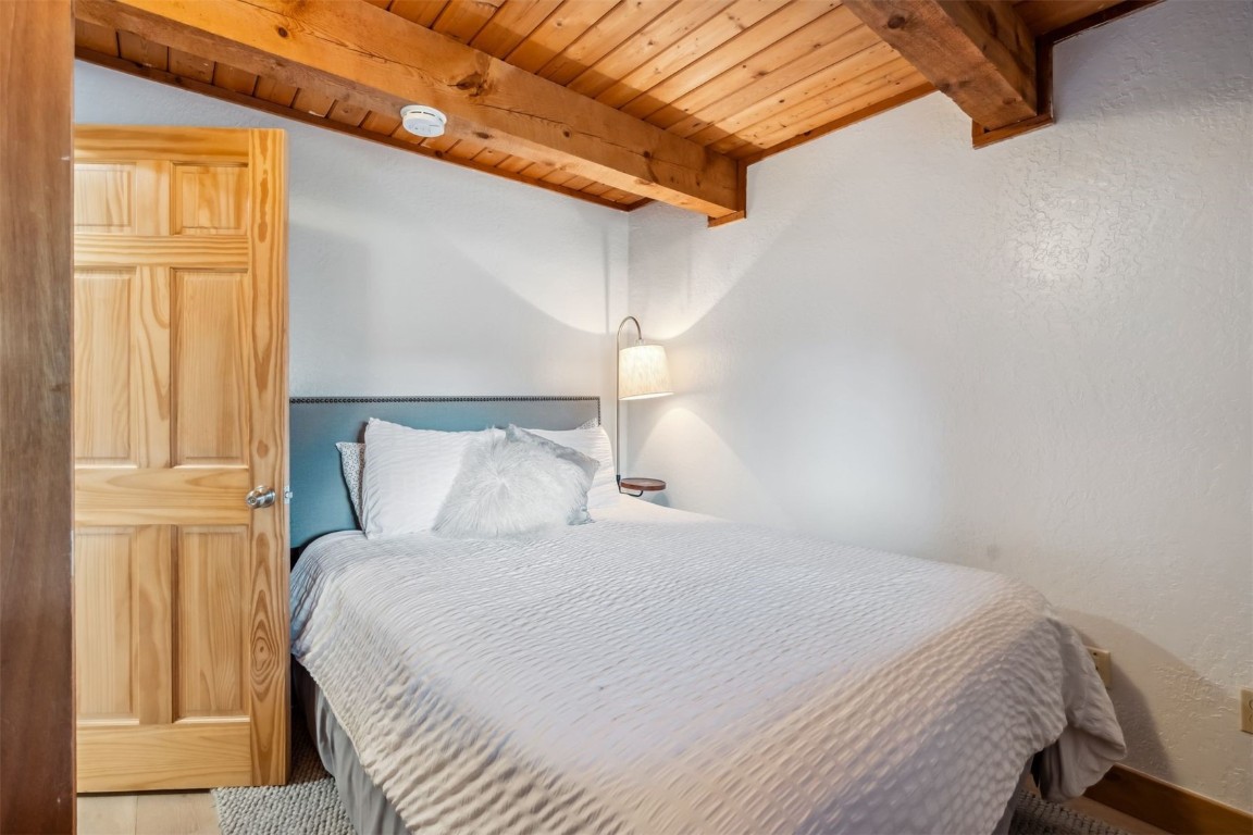 209 Miners Creek Road Frisco, CO 80443 - Photo 13 of 32 a bedroom with a bed and a window