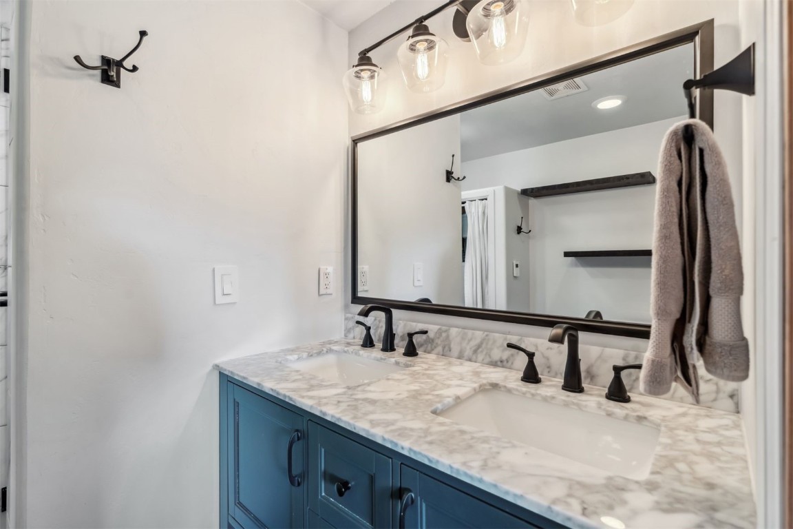 209 Miners Creek Road Frisco, CO 80443 - Photo 19 of 32 a bathroom with a granite countertop sink and a mirror