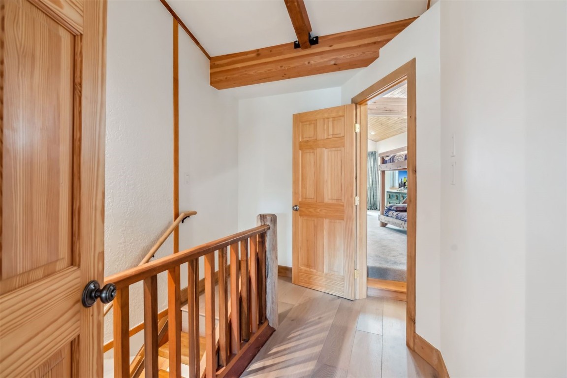 209 Miners Creek Road Frisco, CO 80443 - Photo 28 of 32 a view of a hallway with wooden floor and staircase