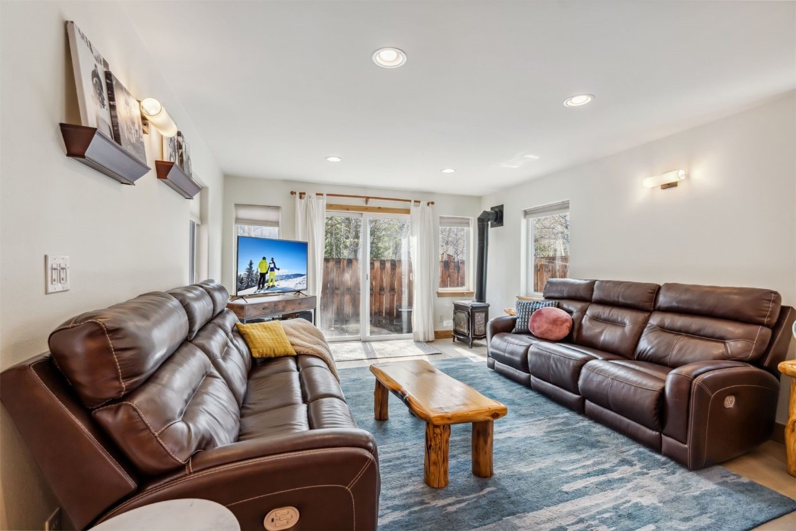209 Miners Creek Road Frisco, CO 80443 - Photo 3 of 32 a living room with furniture a ceiling fan and a rug