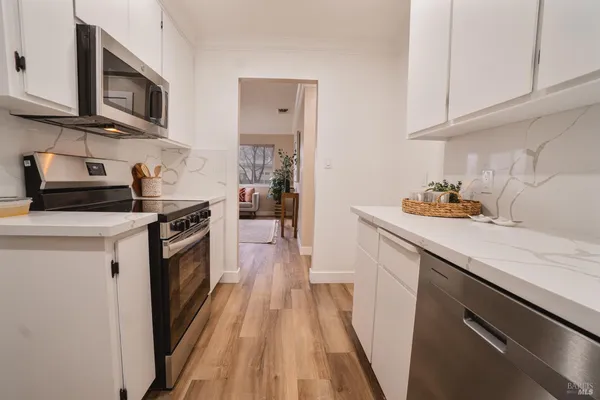 a kitchen with stainless steel appliances a stove microwave and cabinets