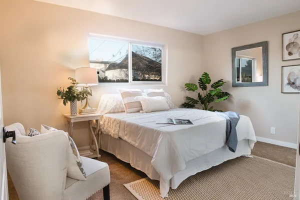 a bedroom with a bed and window