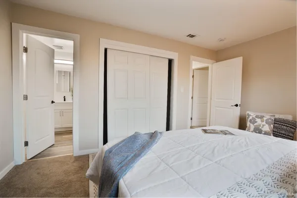 a bedroom with a bed and a mirror