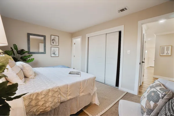 a bedroom with a bed and a couch