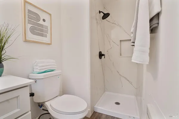 a white toilet sitting next to a bathroom sink