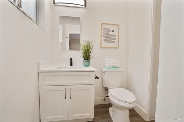 a bathroom with a toilet sink and mirror