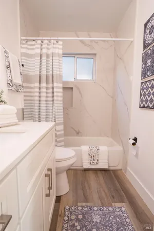 a bathroom with a sink a toilet and shower