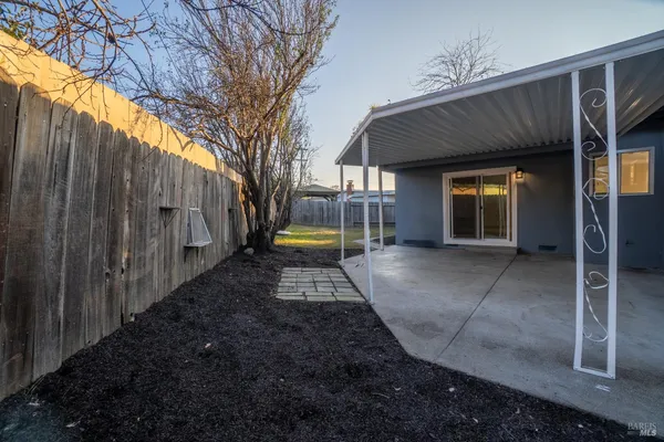 a view of a house with backyard and sitting area