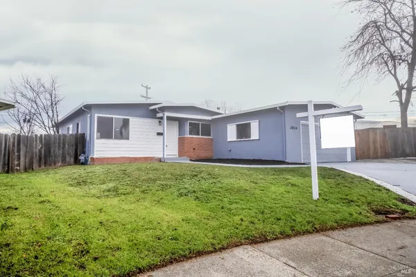 a backyard of a house with table and chairs