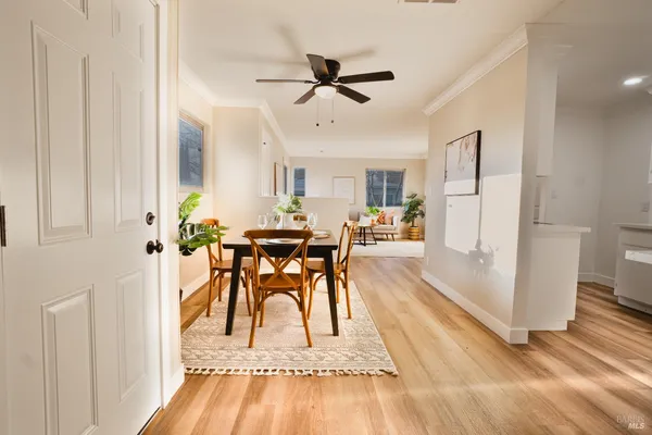 a view of a dining room with furniture and a wooden floor