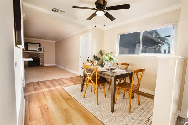 a view of a dining room with furniture and a rug