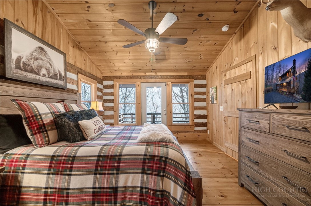 376 Yellow Bear Road Todd, NC 28684 - Photo 12 of 29 a bedroom with a bed a dresser and flat screen tv