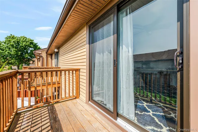 a view of a patio with dining table and chairs with wooden floor fence and a yard