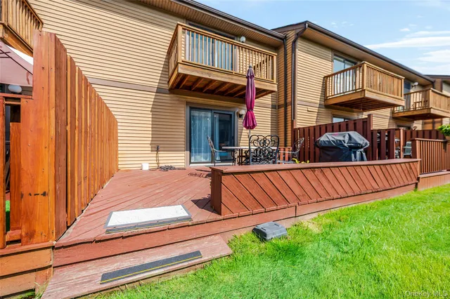 a view of a balcony with yard