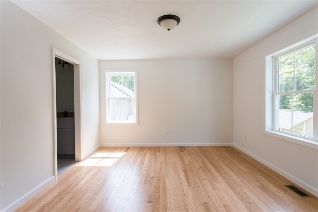 455 Cronin Road West Brookfield, MA 01585 - Photo 15 of 35 an empty room with wooden floor and windows