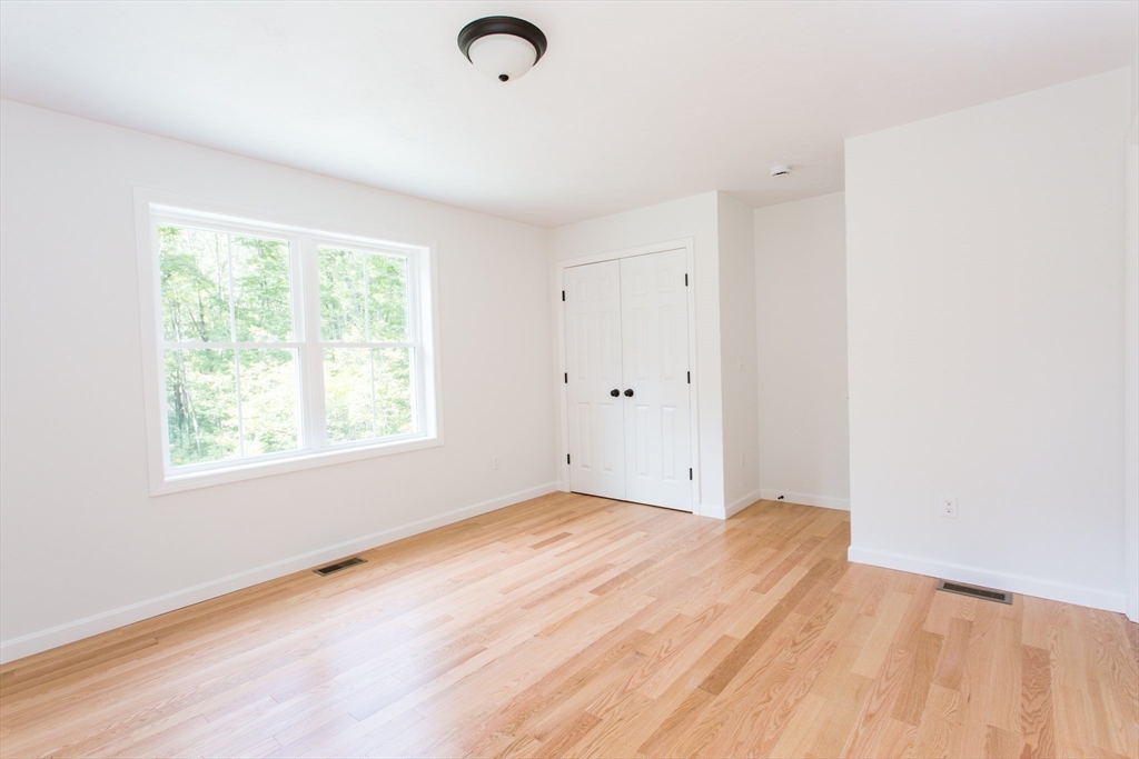 455 Cronin Road West Brookfield, MA 01585 - Photo 16 of 35 an empty room with wooden floor and windows