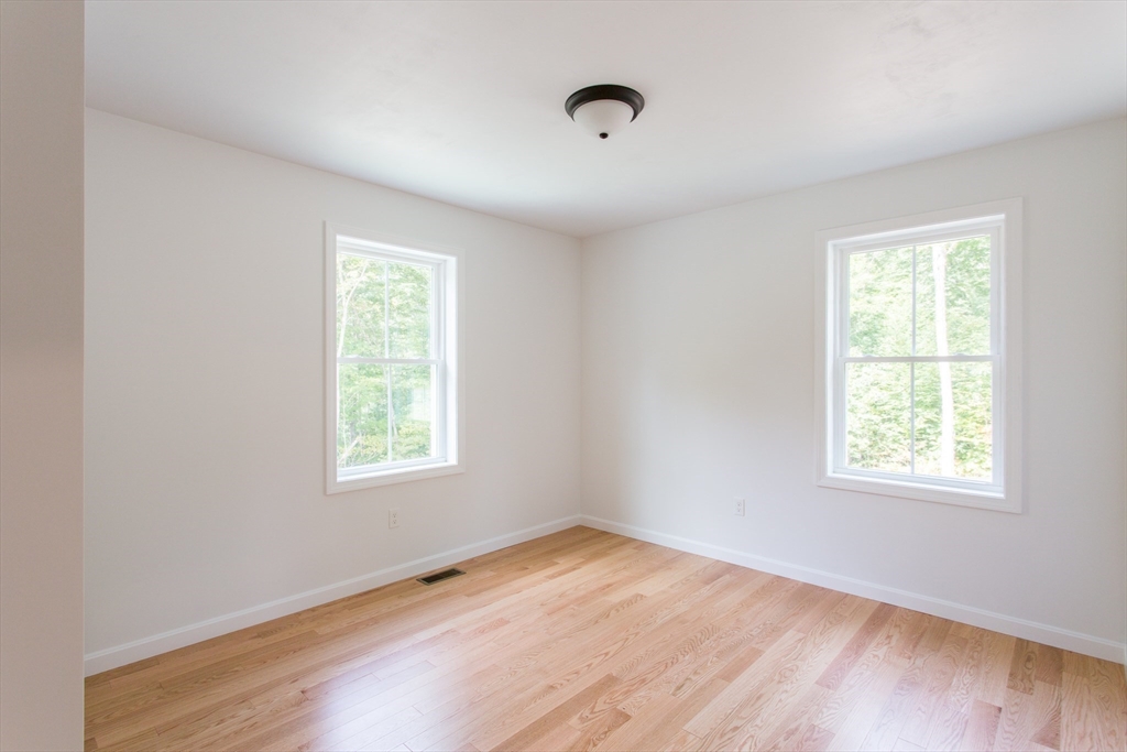 455 Cronin Road West Brookfield, MA 01585 - Photo 20 of 35 an empty room with wooden floor and windows