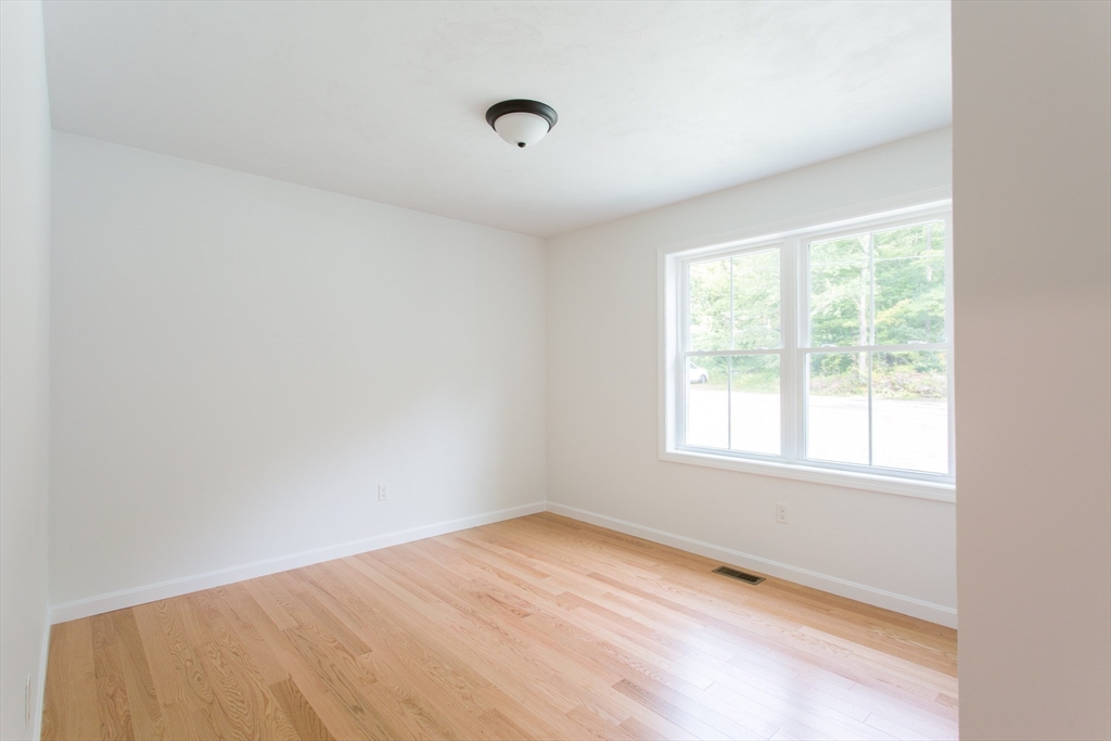 455 Cronin Road West Brookfield, MA 01585 - Photo 22 of 35 an empty room with wooden floor and windows