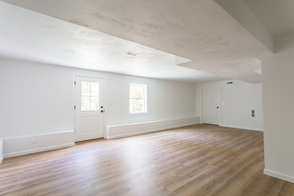 455 Cronin Road West Brookfield, MA 01585 - Photo 26 of 35 an empty room with wooden floor and windows
