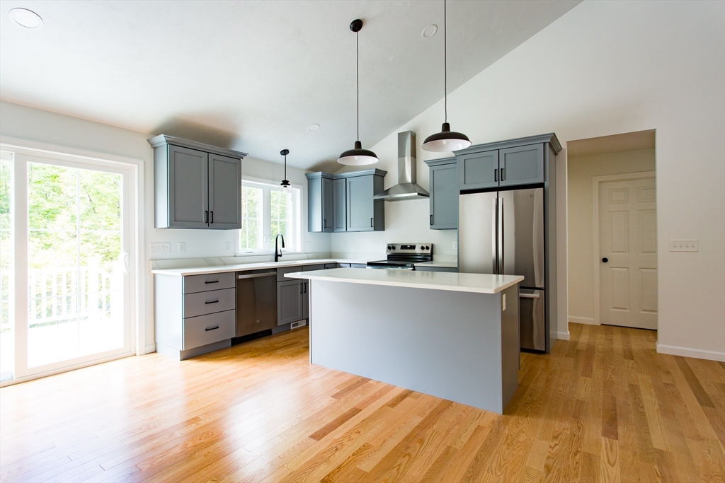 455 Cronin Road West Brookfield, MA 01585 - Photo 3 of 35 a kitchen with stainless steel appliances granite countertop a refrigerator a sink dishwasher a stove and white countertops with wooden floor