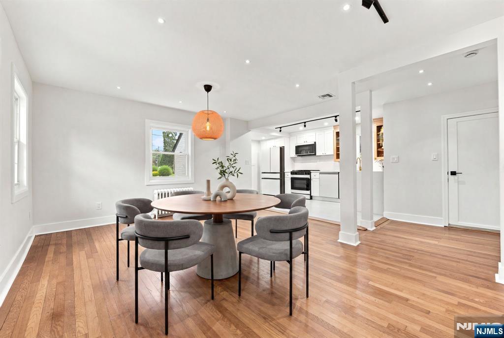 867 River Road Teaneck, NJ 07666 - Photo 9 of 45 a view of a dining room with furniture and wooden floor