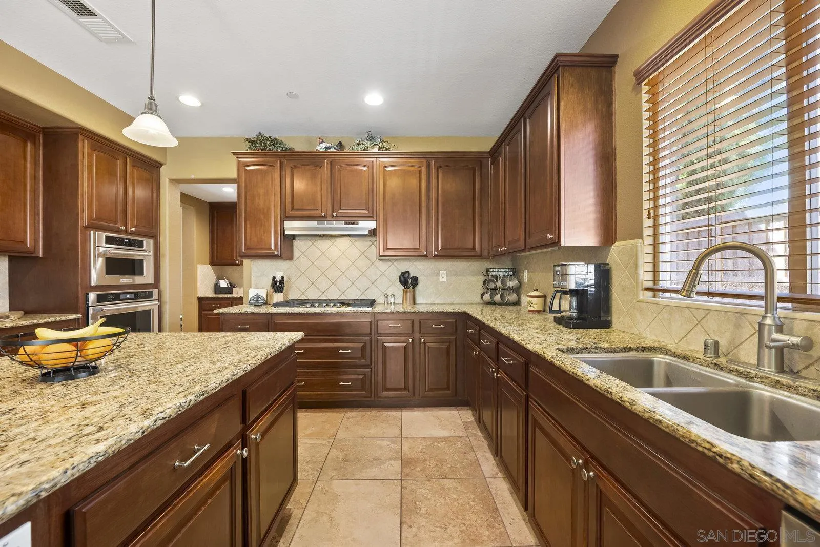 5545 Nanday Court Oceanside, CA 92057 - Photo 14 of 38 a kitchen with a sink stove top oven and cabinets