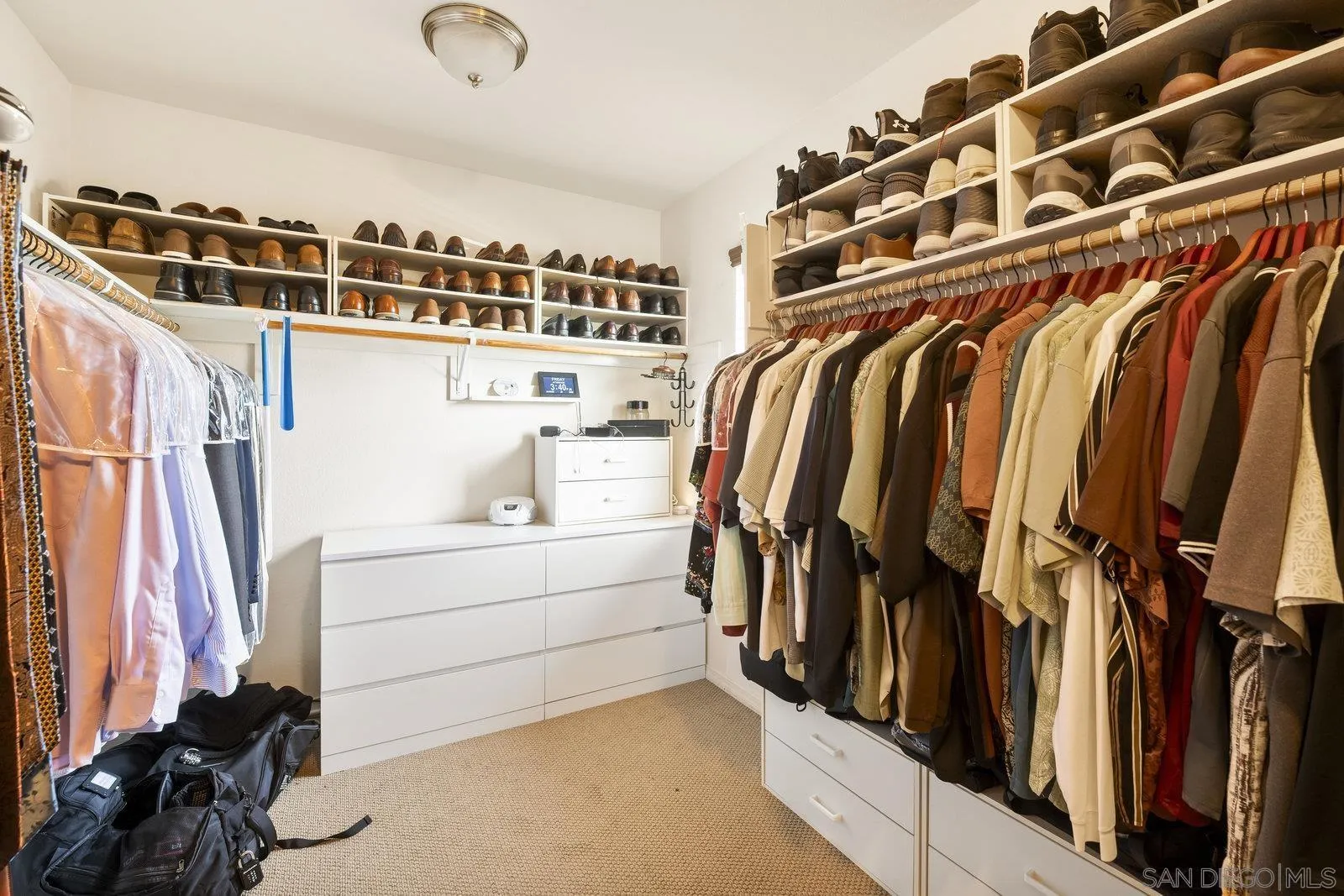 5545 Nanday Court Oceanside, CA 92057 - Photo 27 of 38 a view of walk in closet with clothes and shoes