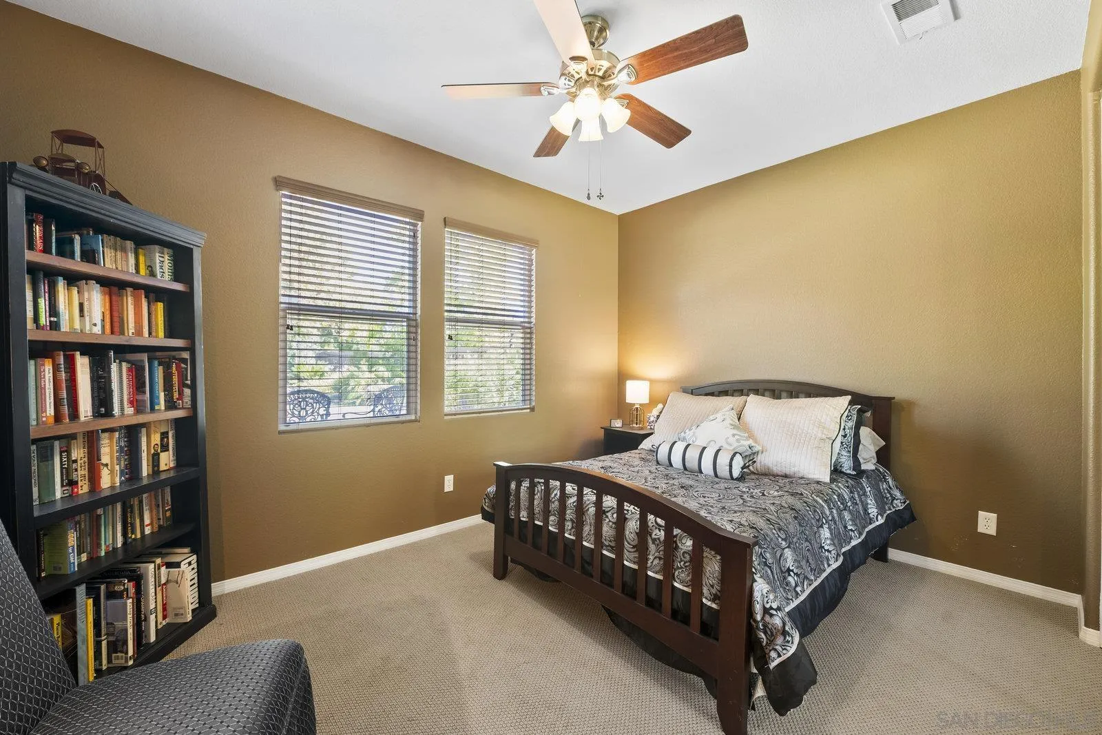 5545 Nanday Court Oceanside, CA 92057 - Photo 34 of 38 a bedroom with a bed and a book shelf