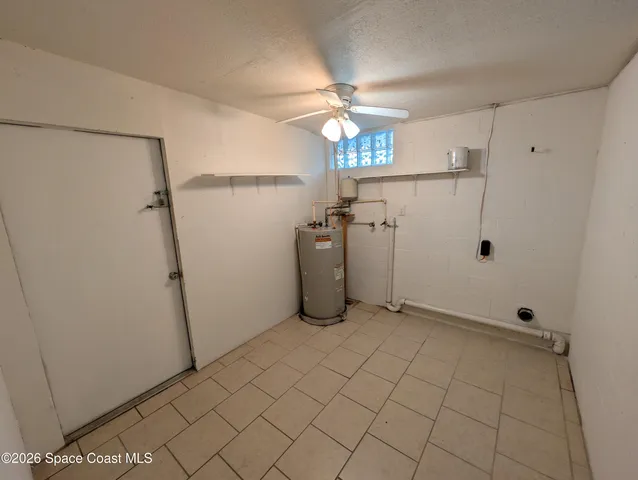 a view of a storage & utility room with racks on the wall